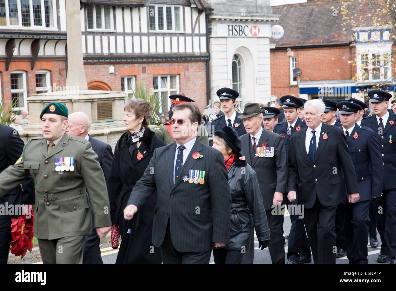 A Remembrance Day procession passes the War Memorial in Haslemere town centre, Surrey, England. Stock Photo