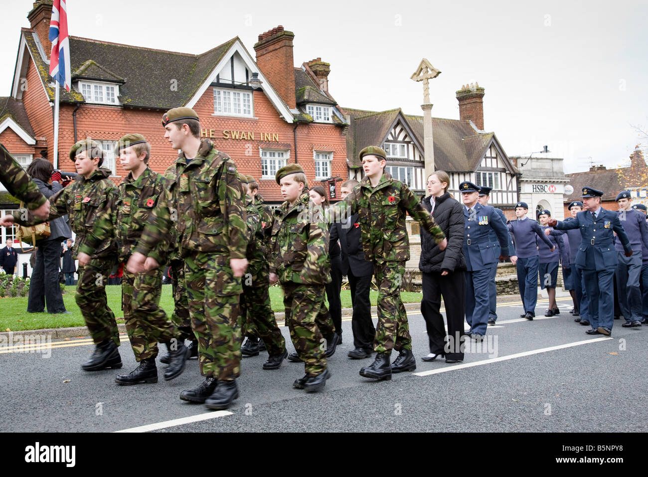 A Remembrance Day procession passes the War Memorial in Haslemere town centre, Surrey, England. Stock Photo