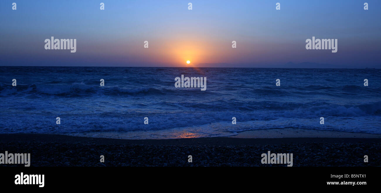 Beautiful sunset in Rodos, in front of Cafe Iguana, Rhodes Beach, Greece. Stock Photo