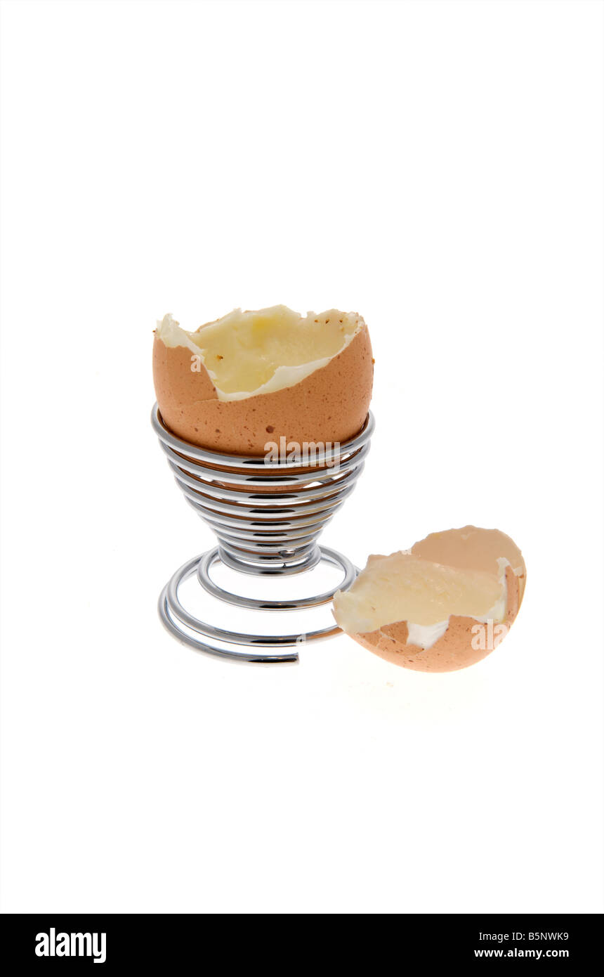 Empty Boiled egg sitting in egg cup with top cut off Stock Photo