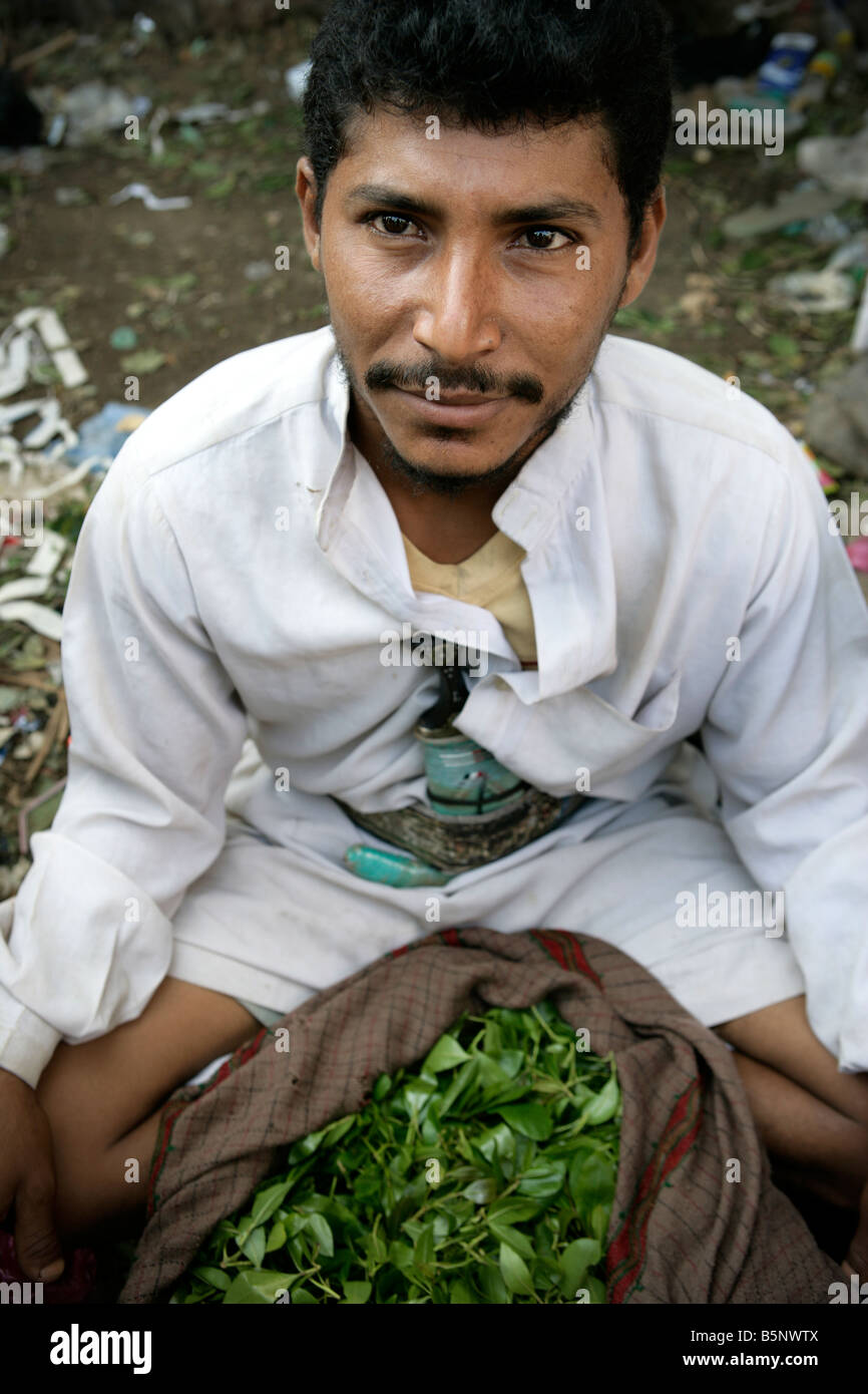 Man with large bundle of Qat leaves for sale in Qat market, Yemen Stock Photo
