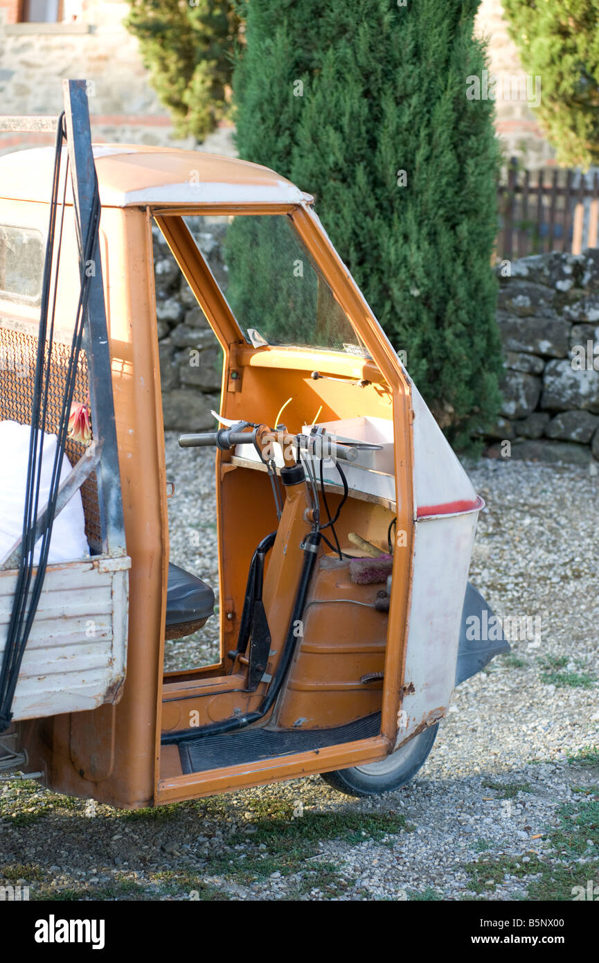 Well used Ape three wheeled utility vehicle in Tuscan village, near Monte San Savino, Italy. Stock Photo