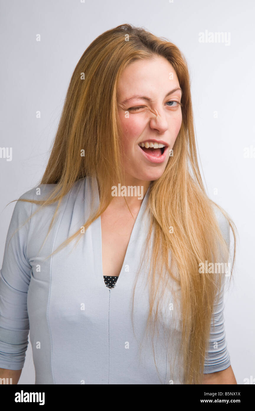 Girl With Long Straight Blonde Hair Young Woman Winking At The