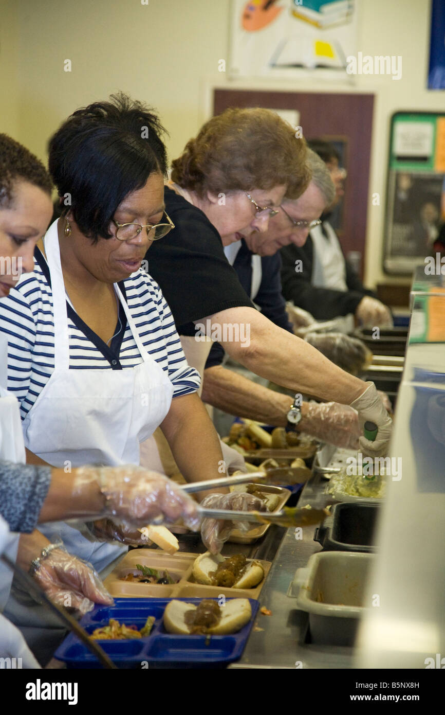 Volunteers Serve Lunch in Soup Kitchen Stock Photo