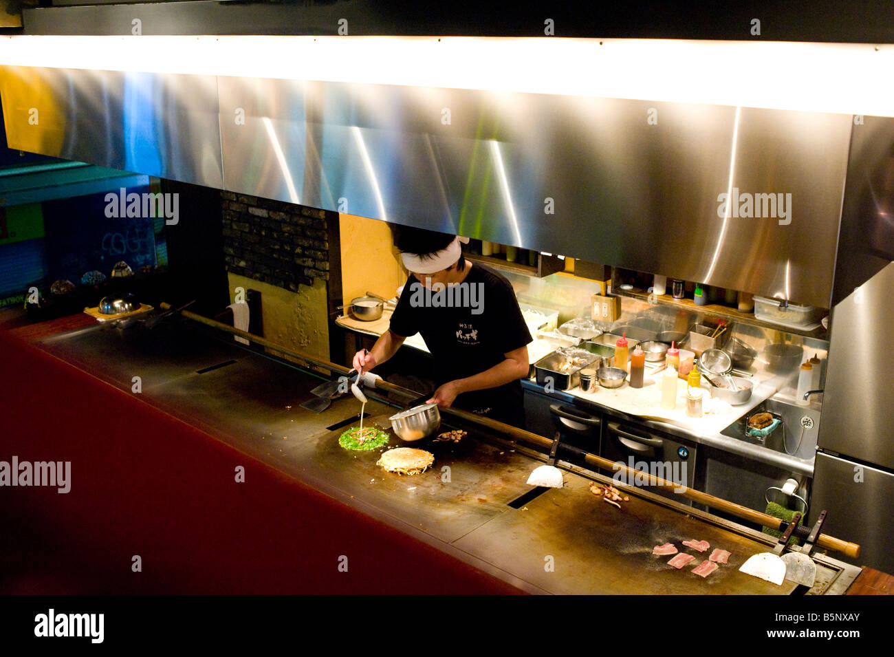 Chef cooking in an Okonomiyaki restaurant in the Shibuya district in