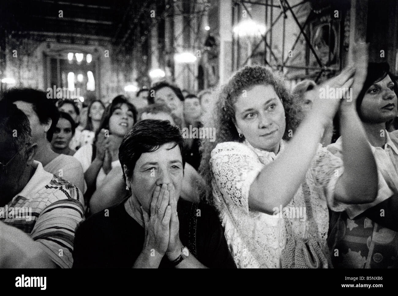 A crowd celebrates the miraculous liquification of St Genaro's blood which happens three times a year, Naples Cathedral, Italy Stock Photo