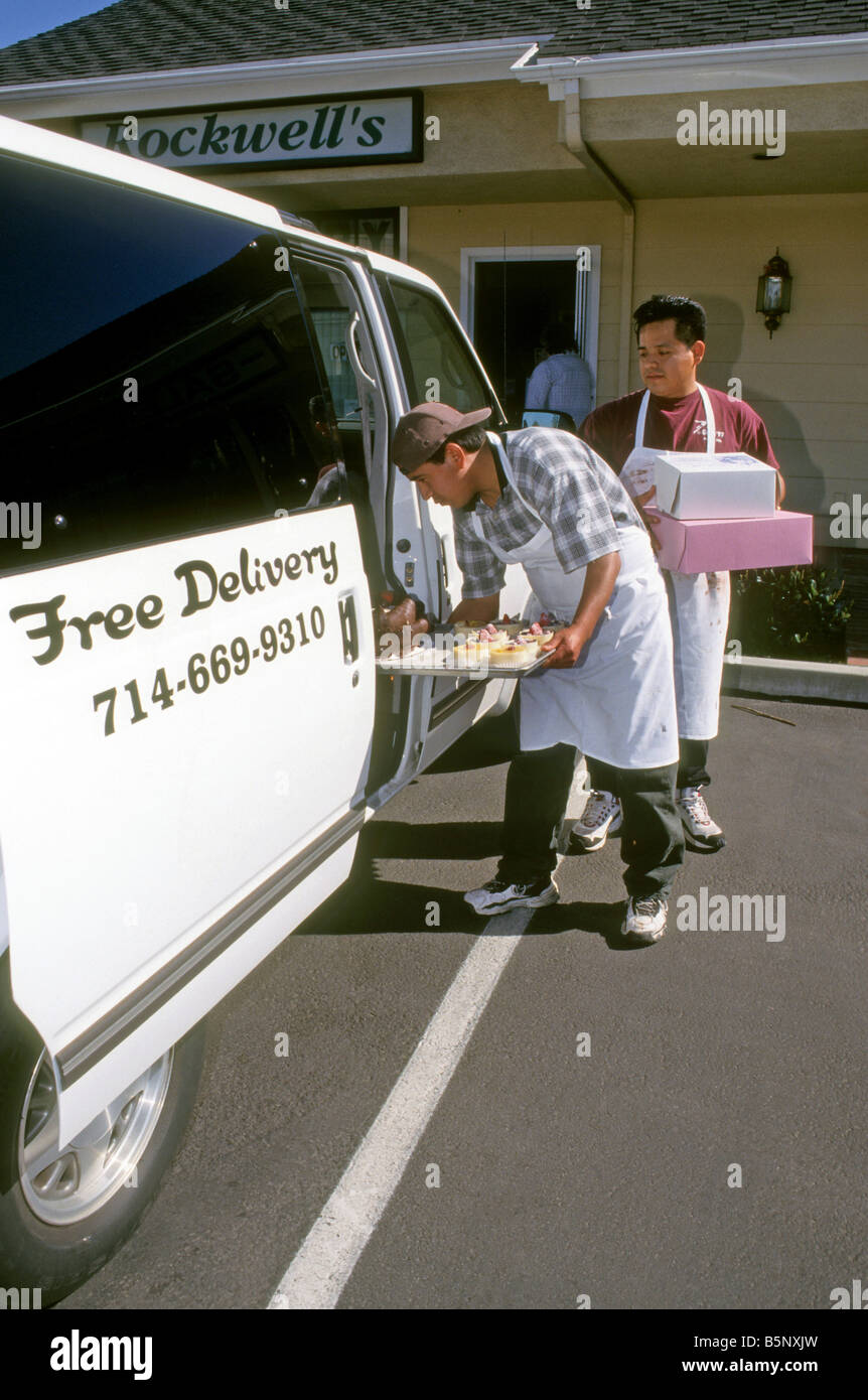 Bakers load cakes into van for delivery from bakery Stock Photo - Alamy