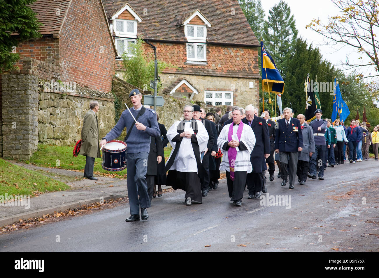 A Remembrance Day procession en route from the church to the War Memorial in Haslemere town centre, Haslemere, England. Stock Photo