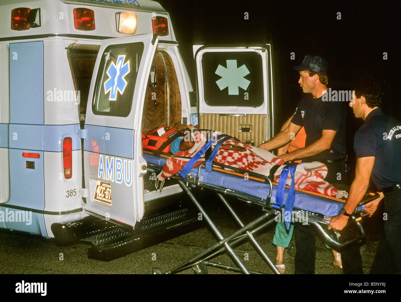 Injured Driver Is Loaded Into Ambulance After Auto Accident Stock Photo ...