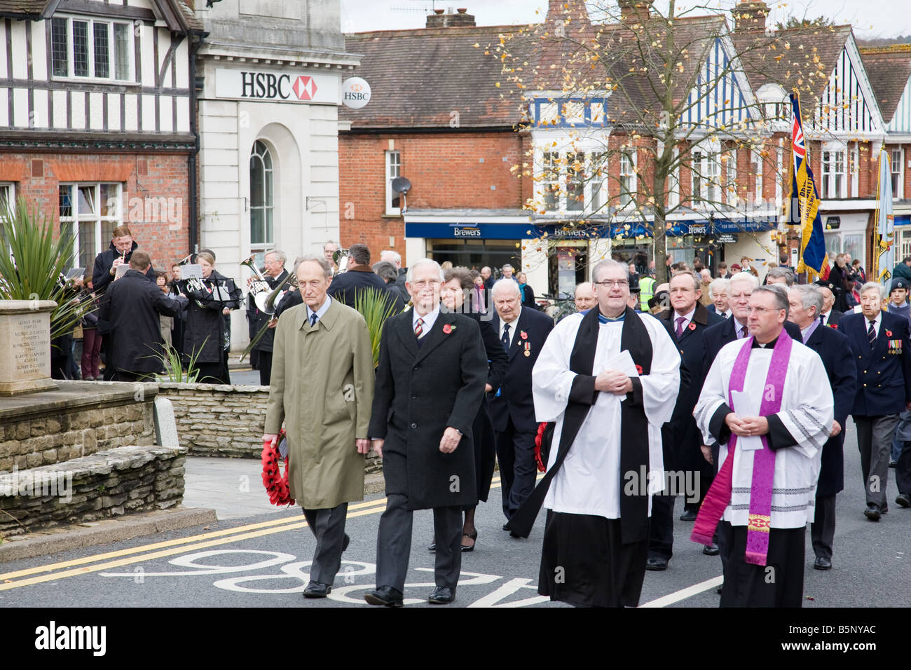 A Remembrance Day procession approaches the War Memorial in Haslemere town centre, Surrey, England. Stock Photo
