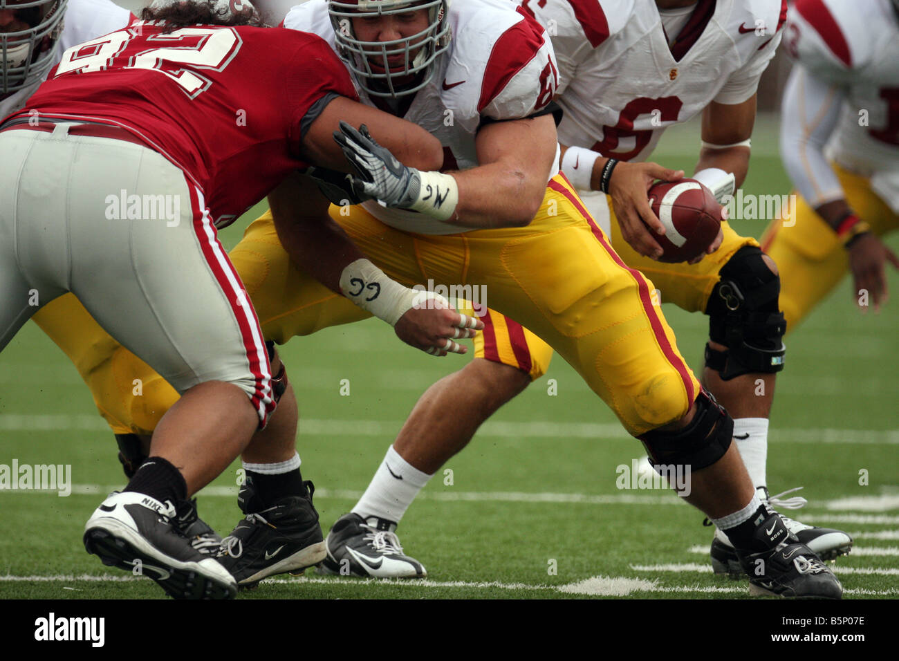 USC center, Kristofer O'Dowd (#61), blocks after hiking the ball to quarterback Mark Sanchez during a Pac-10 game against WSU. Stock Photo