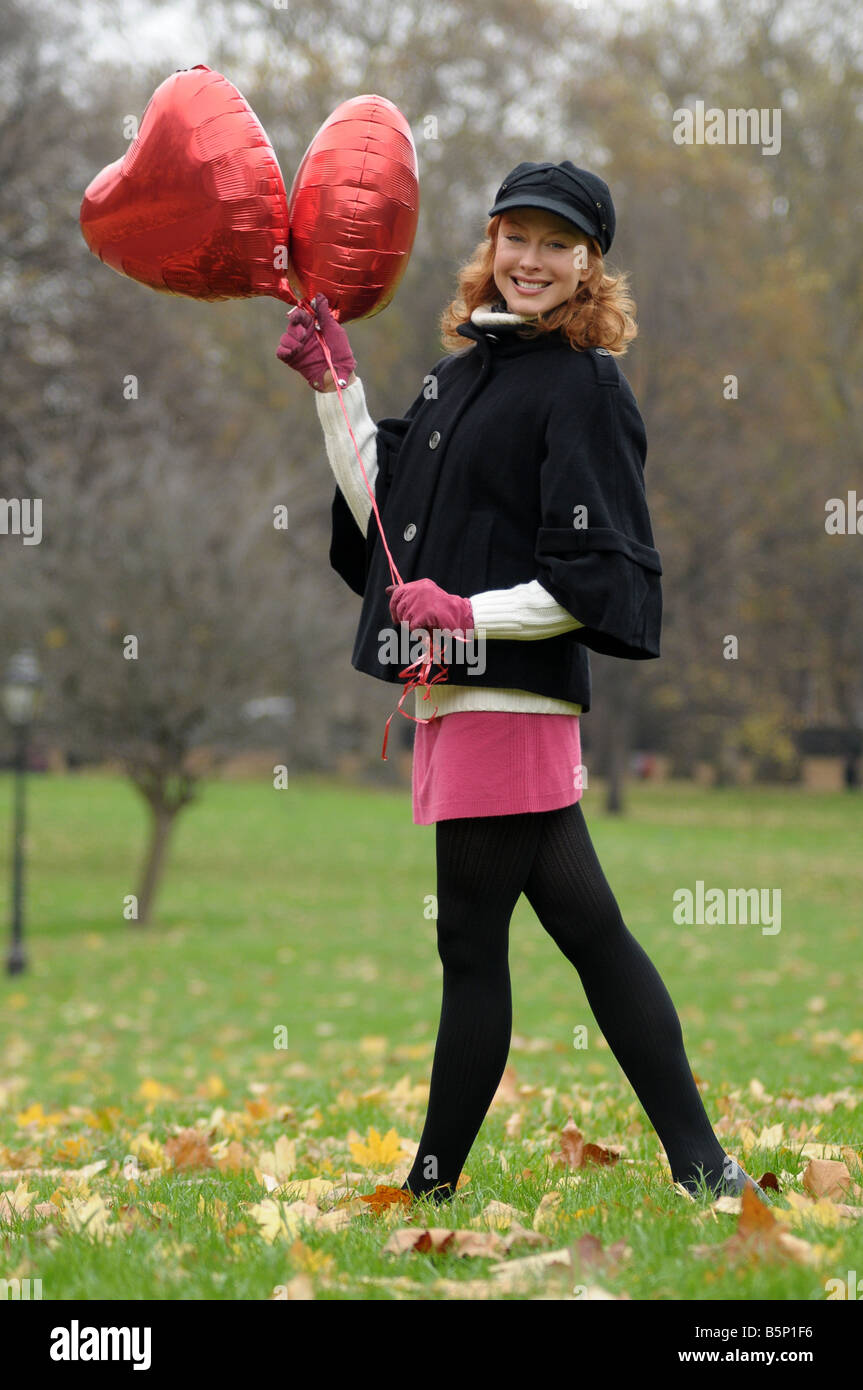 Woman holding red balloons Stock Photo