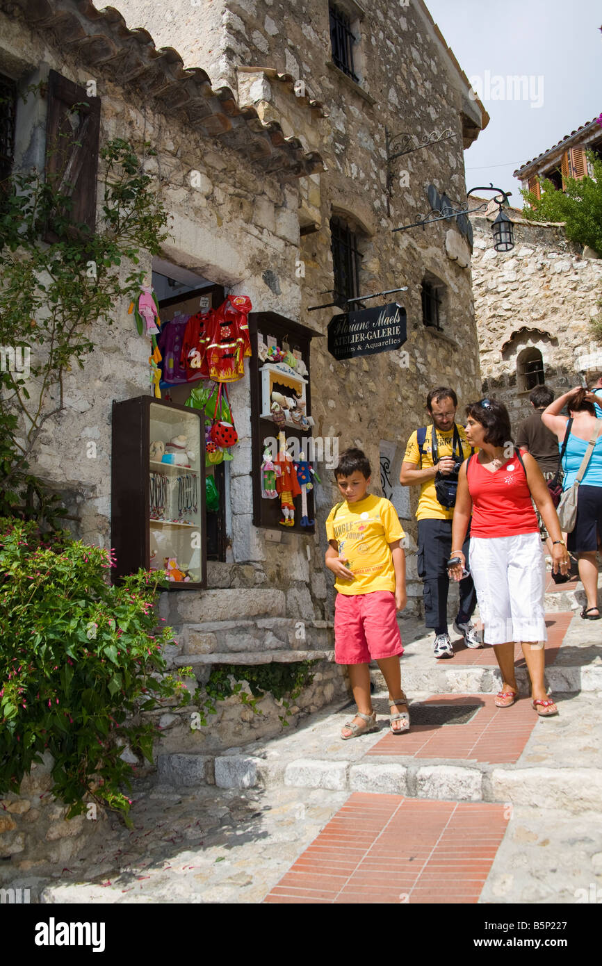 Tourists walking past a gift shop in the medieval village of Eze, near Monaco, France Stock Photo