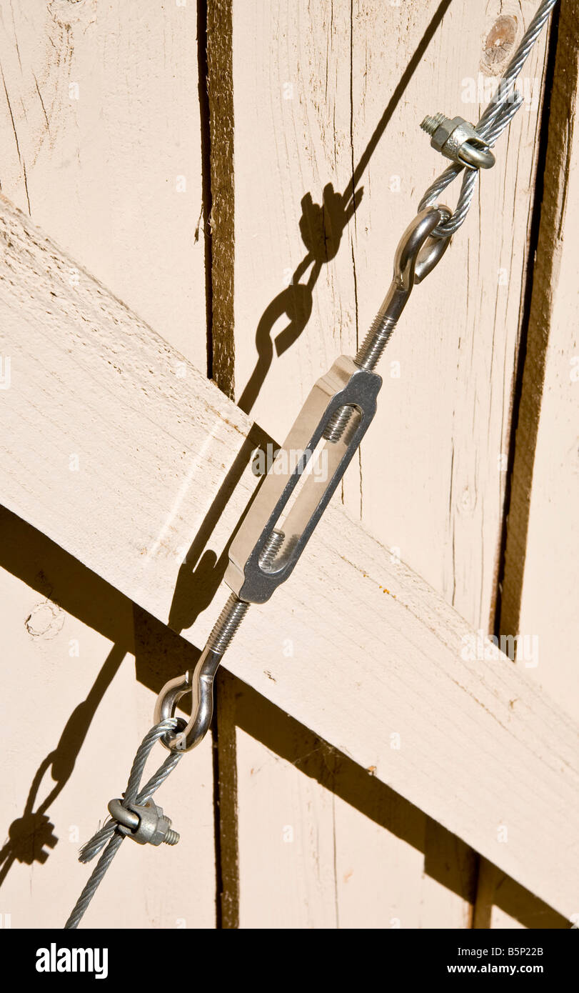 Wooden gate with wire support with turnbuckle Stock Photo