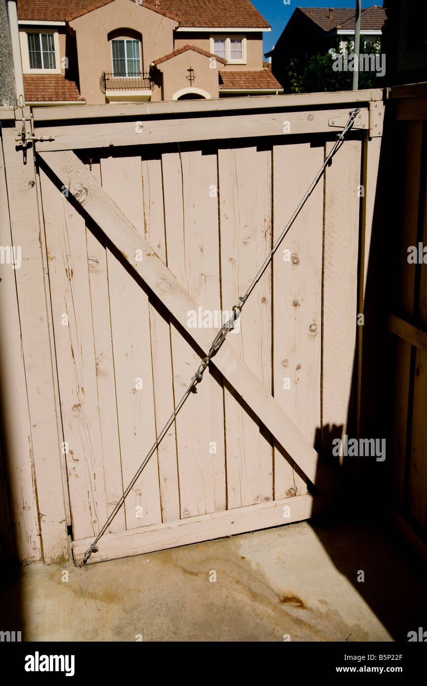 Wooden gate with wire support with turnbuckle Stock Photo