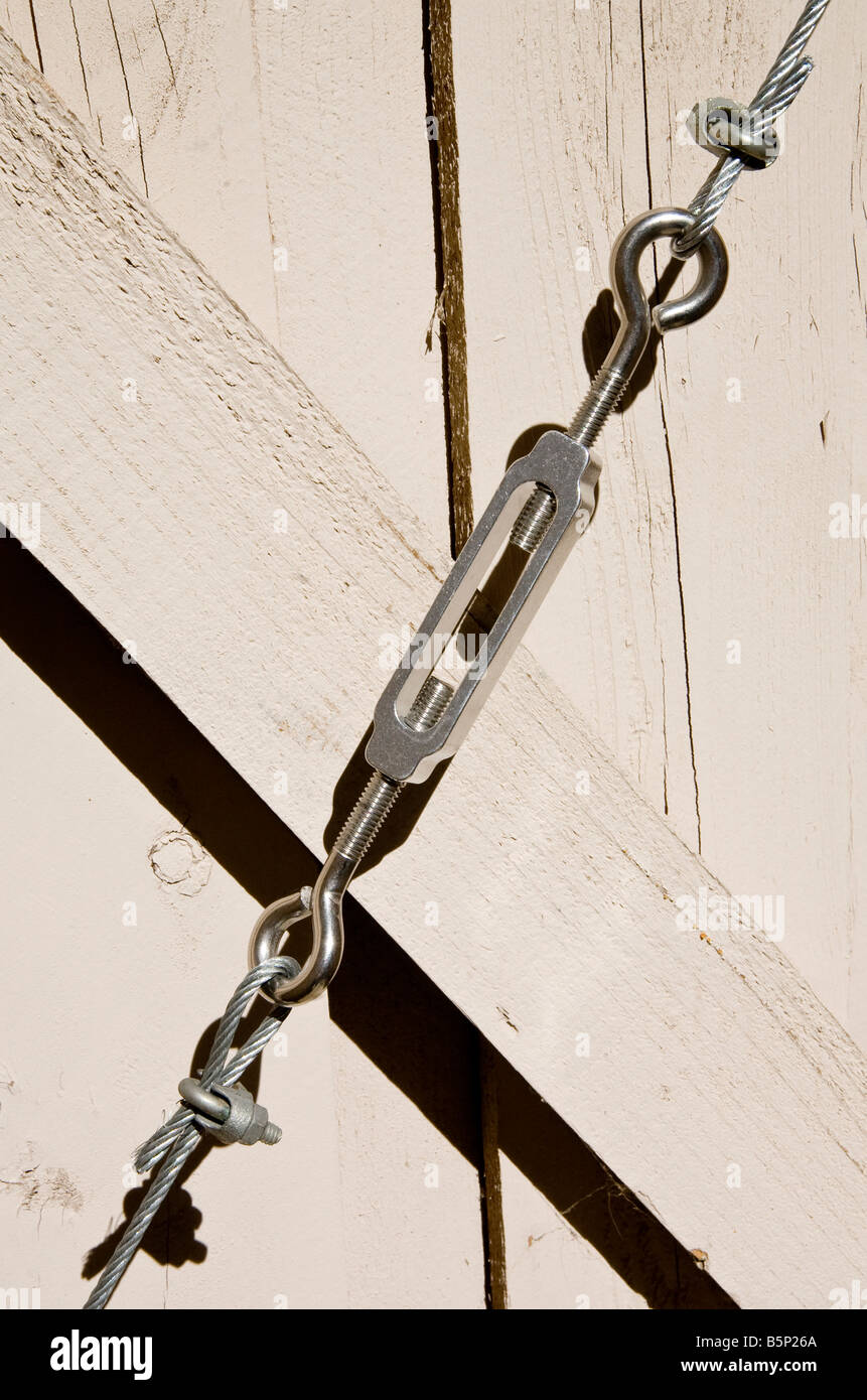 Wooden gate with wire support with turnbuckle Stock Photo