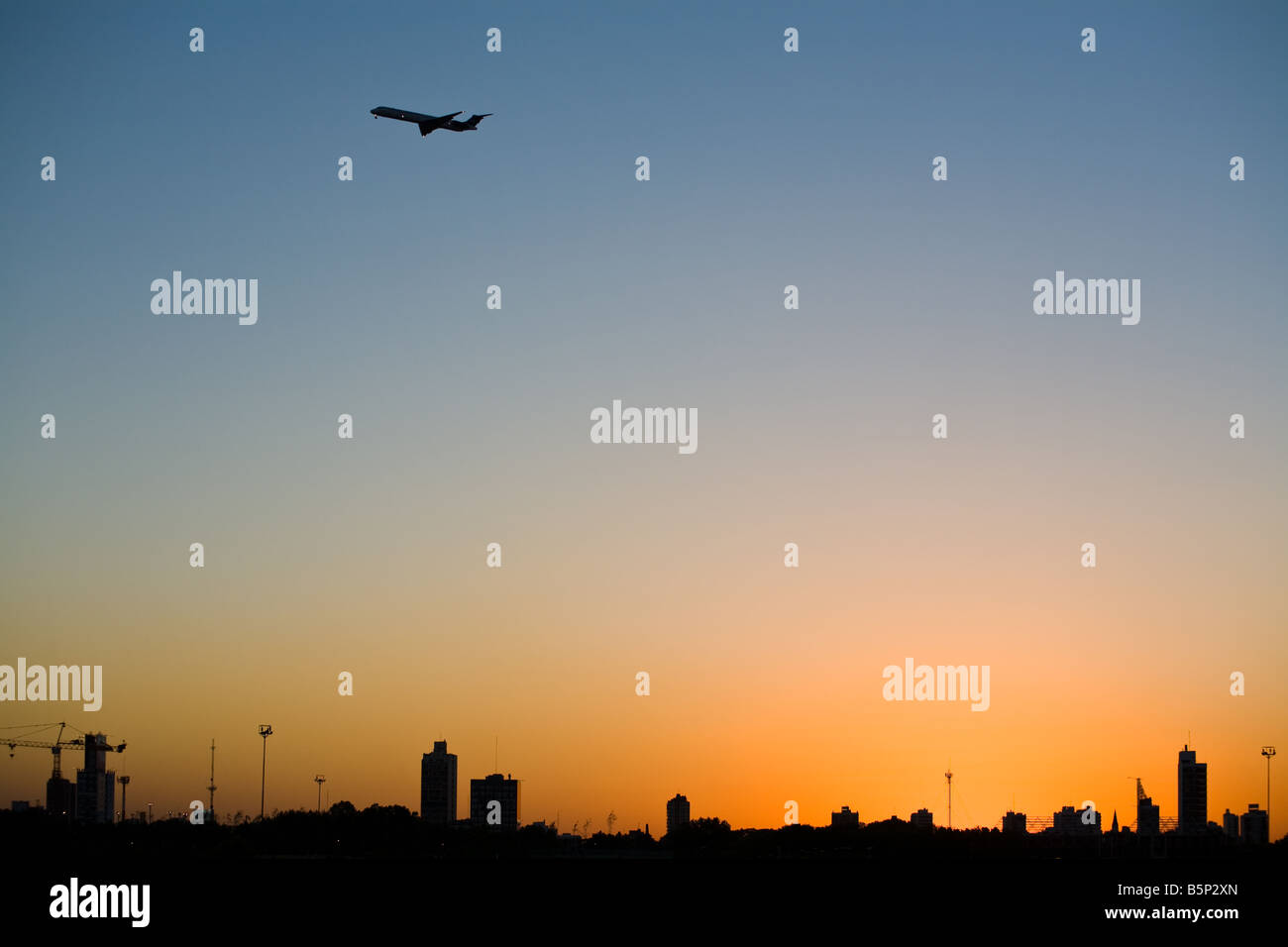 Buenos Aires city silhouette at sunset from Rio de la Plata river. Plain passing by Stock Photo