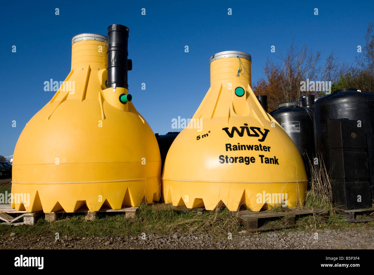 Large yellow plastic Wisy rainwater storage tanks Green Shop Bisley UK