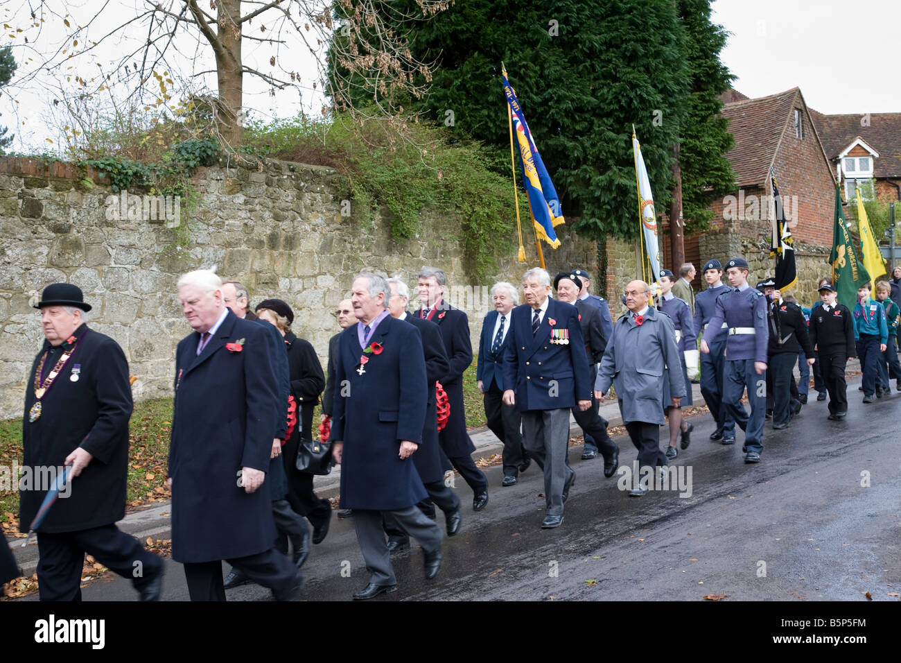 A Remembrance Day procession en route from the church to the War Memorial in Haslemere town centre, Surrey, England. Stock Photo