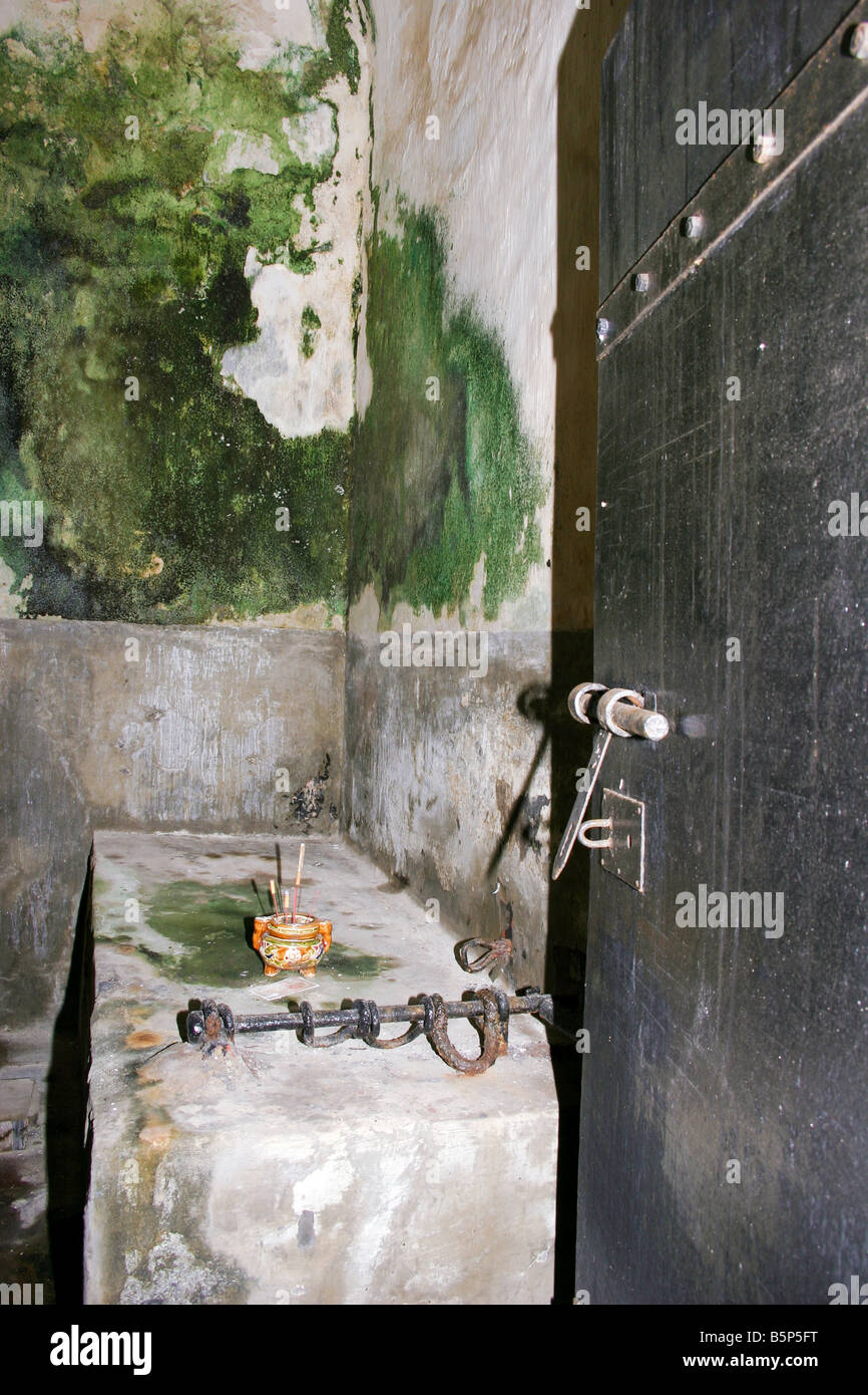 moss covered captivity cell in poulo condor's convict prison with incense present in memory of prisoners, vietnam Stock Photo