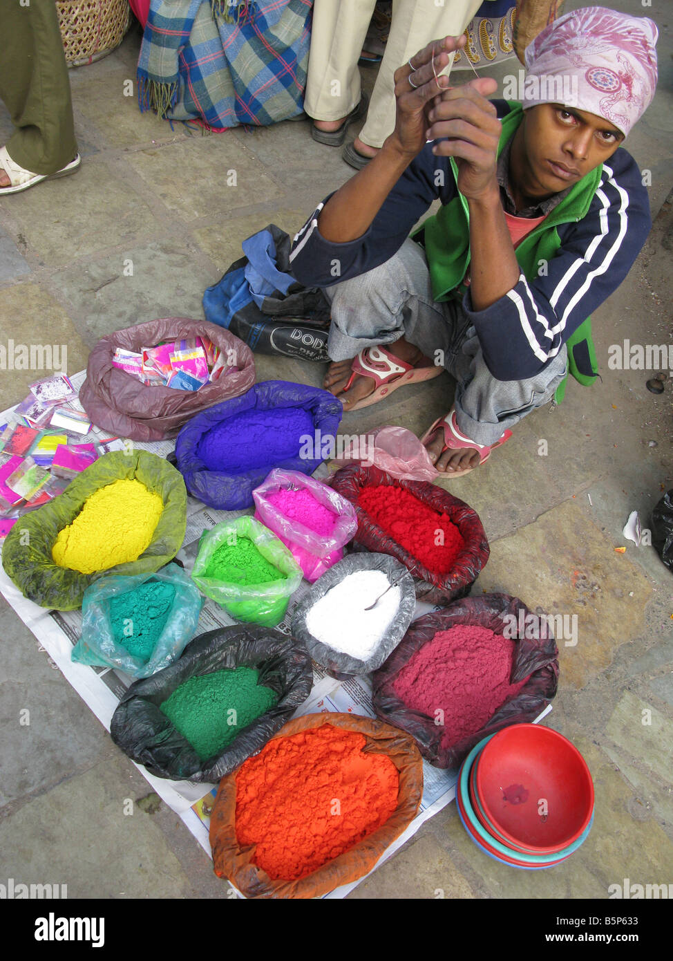 A man selling pigments during Tihar (Diwali), the Festival of Light, on a street in the Indra Chowk area of Kathmandu, Nepal, central Asia Stock Photo