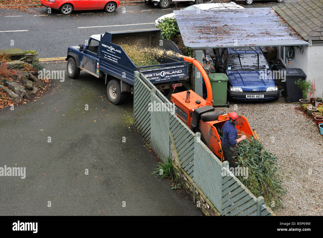 Workman shredding tree cuttings. Beast Banks, Kendal, Cumbria, England, United Kingdom, Europe
