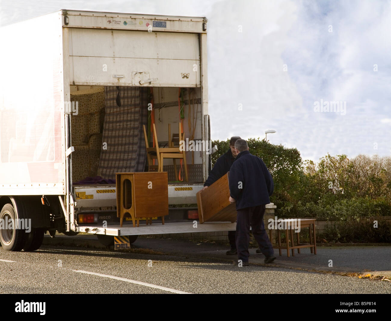North Wales UK Two men loading unwanted furniture into a van for re
