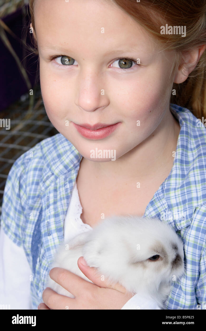 Young girl holding a rabbit Stock Photo - Alamy
