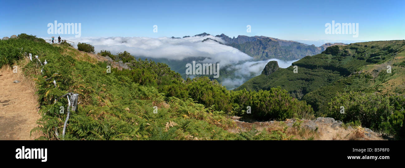Hikers on Bica da Cana with the central mountains of Madeira behind Stock Photo