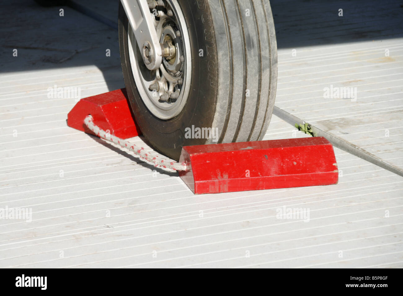 detail of red chocks blocks on fighter jet wheels at open day event