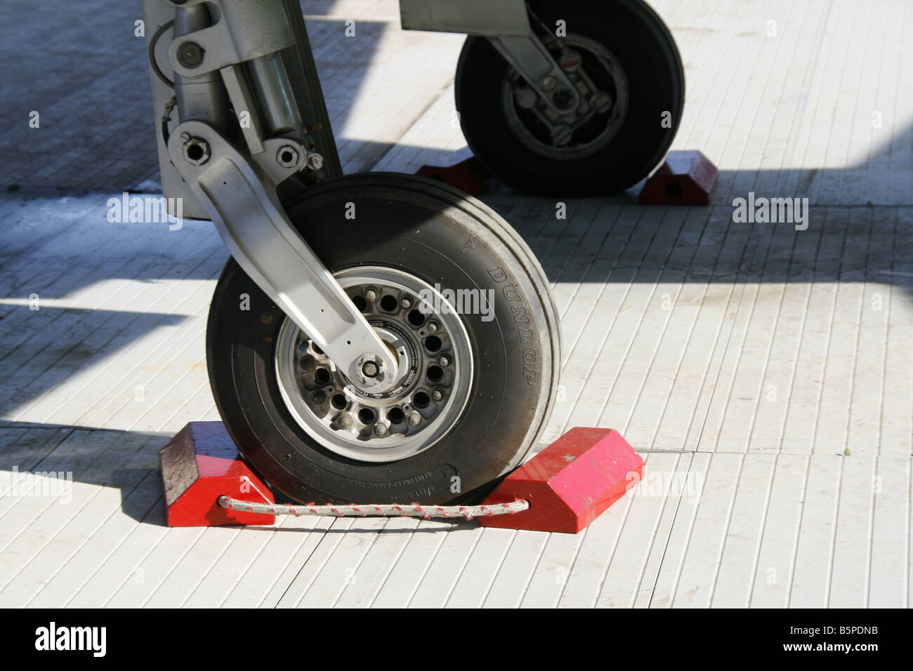detail of red chocks blocks on fighter jet wheels at open day event