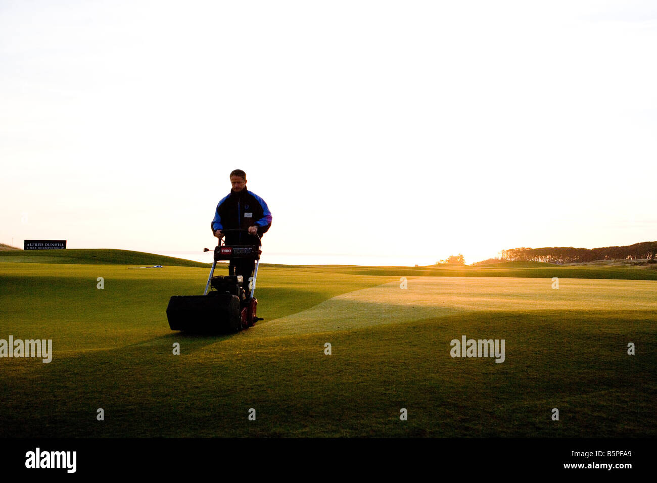 Greenkeeper cutting grass kingsbarns hires stock photography and