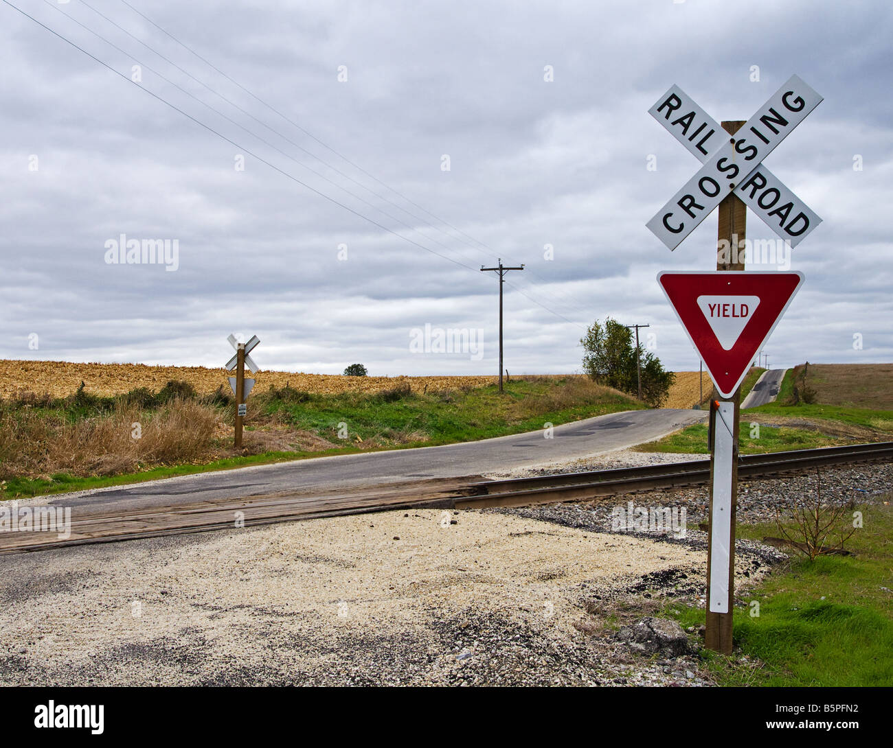 Railroad crossing along a rural road. Stock Photo