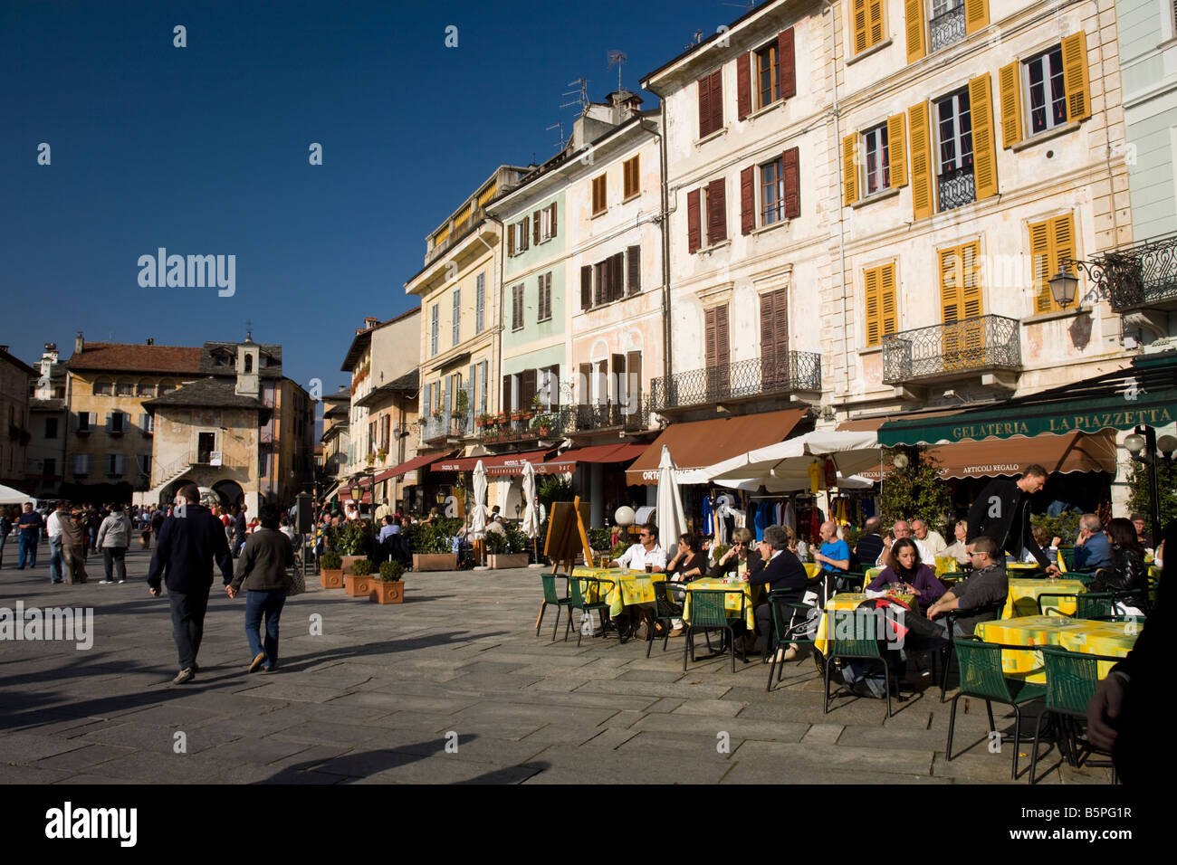 Orta San Giulio, waterfront restaurant and bars with tourists seated