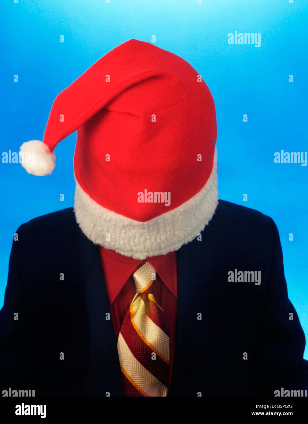 man wearing red white Santa Claus jelly bag cap hat on blue background Stock Photo