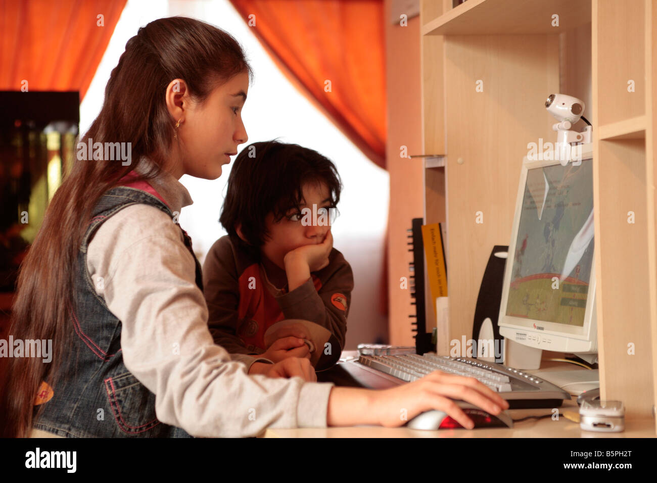 two young children playing nonviolent computer games Stock Photo
