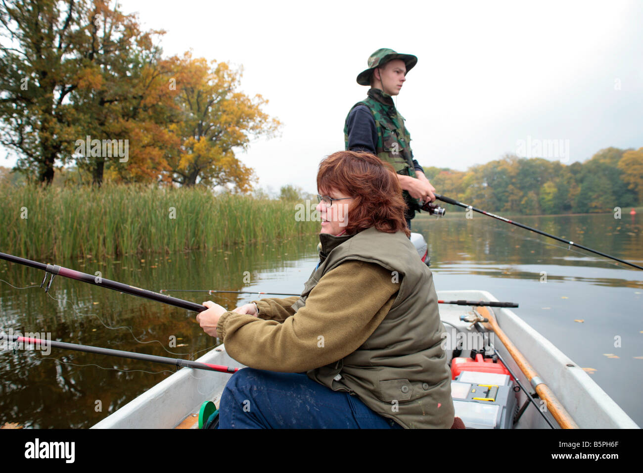 https://c8.alamy.com/comp/B5PH6F/a-teenage-boy-and-his-mother-fishing-from-a-boat-B5PH6F.jpg