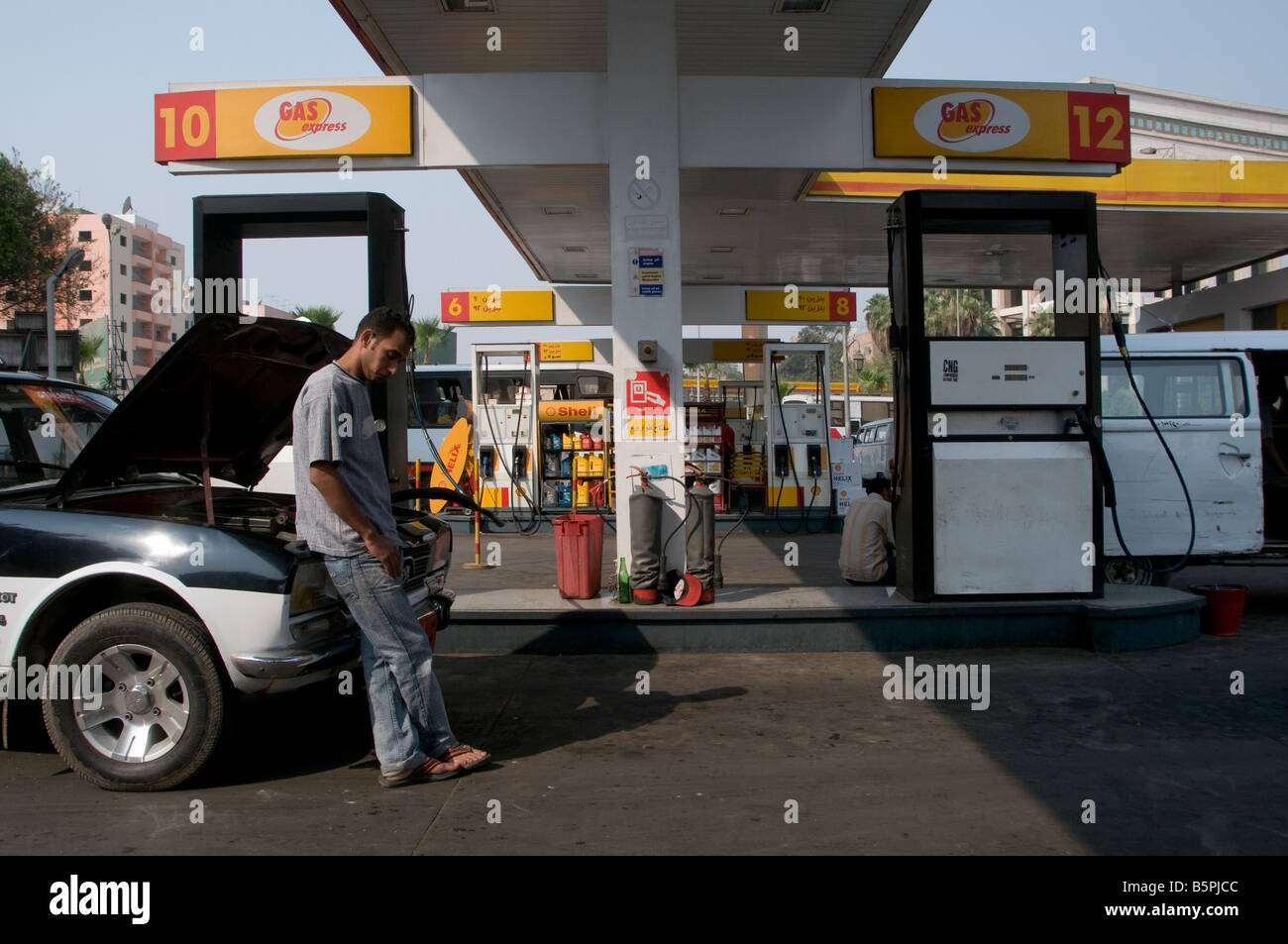 Man filling a taxi car with petrol at a filling station owned bt Gas Express company in Cairo Egypt Stock Photo