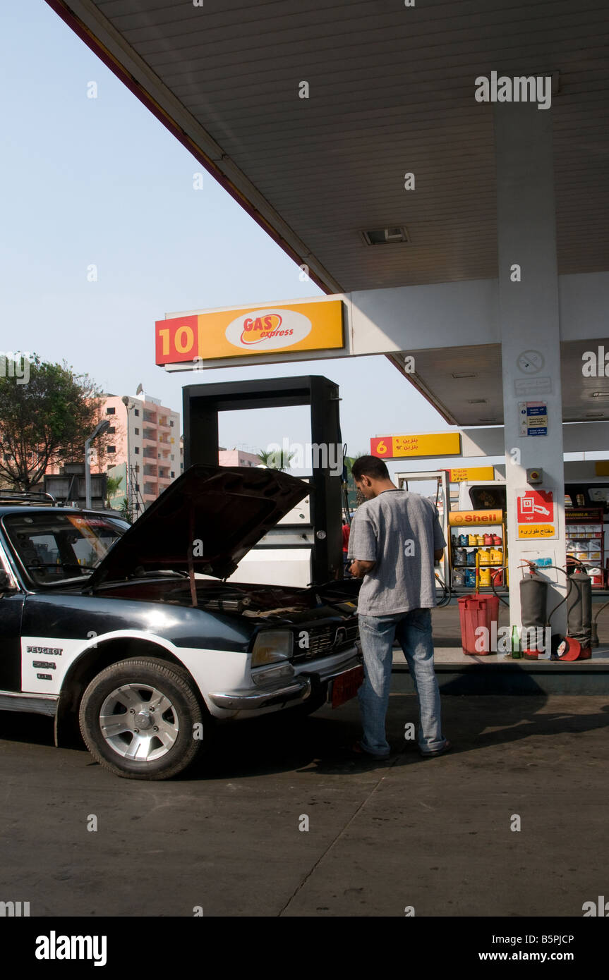 Man filling a taxi car with petrol at a filling station in Cairo Egypt Stock Photo