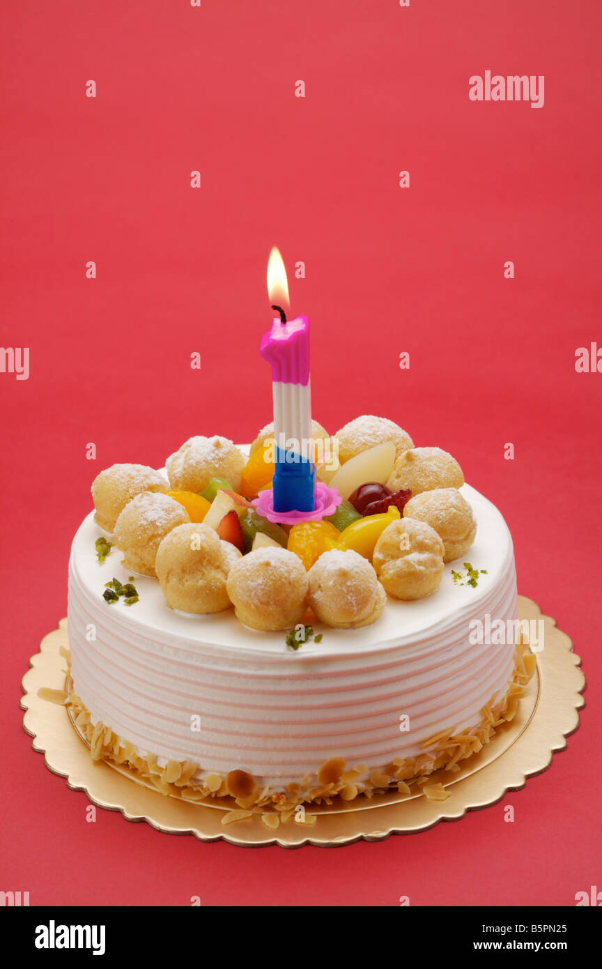 Birthday cake with a candle in the shape of a '1' burning on top Stock