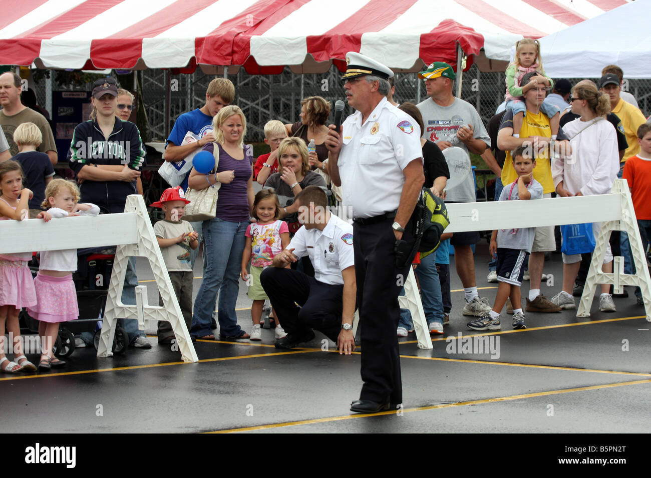 An Fire Department Officer addressing the public attending a Fire Safety Fair Demonstration Stock Photo