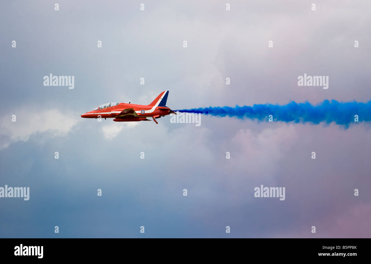 A Royal Airforce Red Arrows Hawk T1 jet aircraft performs a flypast during a display in Gloucestershire, England. Stock Photo