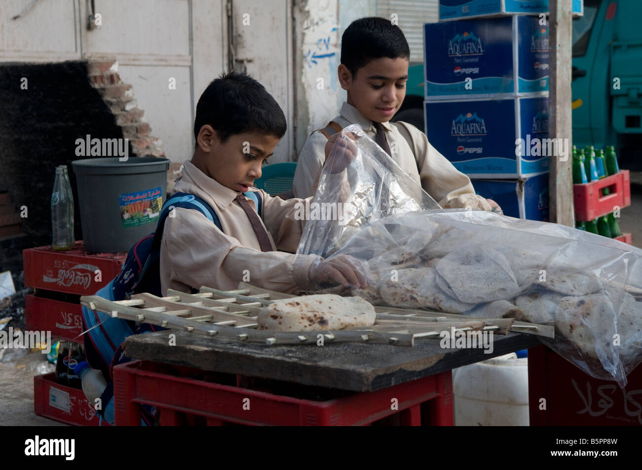 Schoolchildren buying traditional Pita bread on their way to school. Egypt Stock Photo