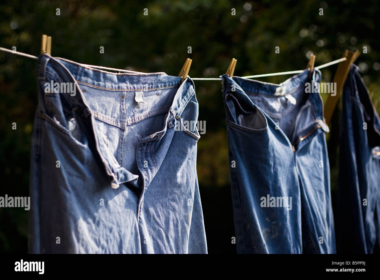 Blue jeans hanging on a clothesline. Stock Photo
