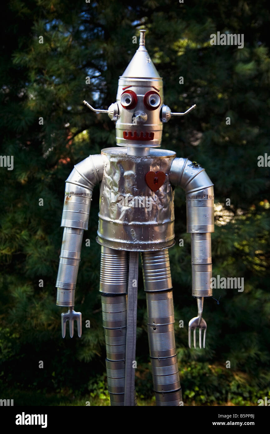 Tin man or robot made out of tin cans and gardening implements wioth