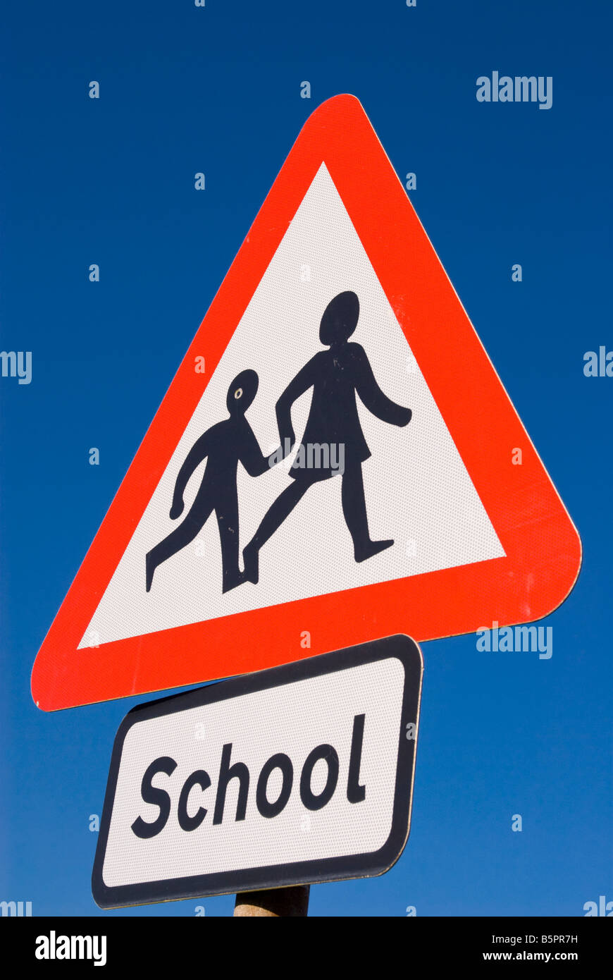 Beware children crossing the road sign outside school gates in uk Stock Photo