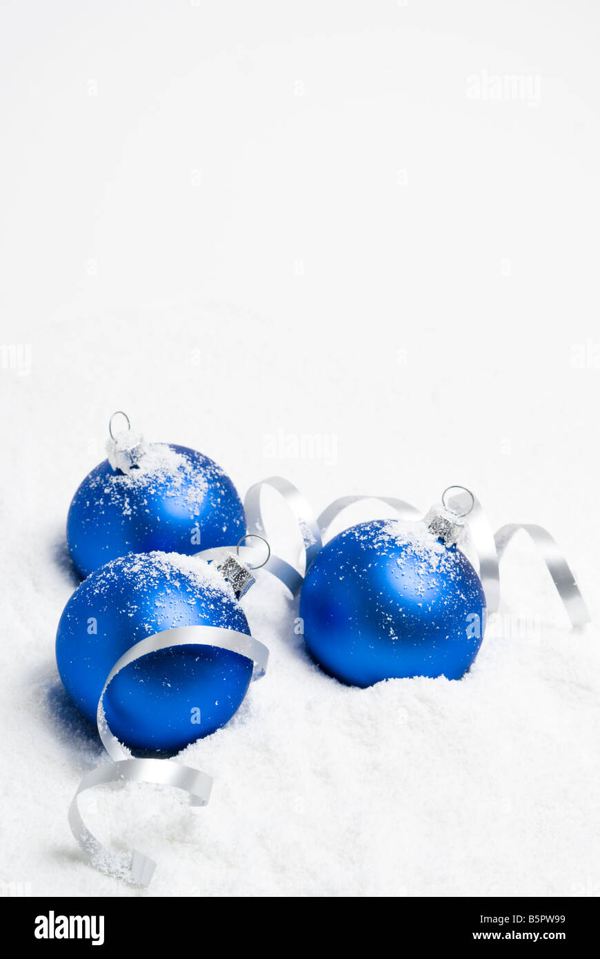 Blue christmas balls lying on the snow. aRGB. Stock Photo