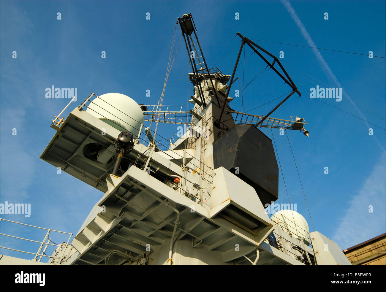 Antennae and radar on navy ship Stock Photo