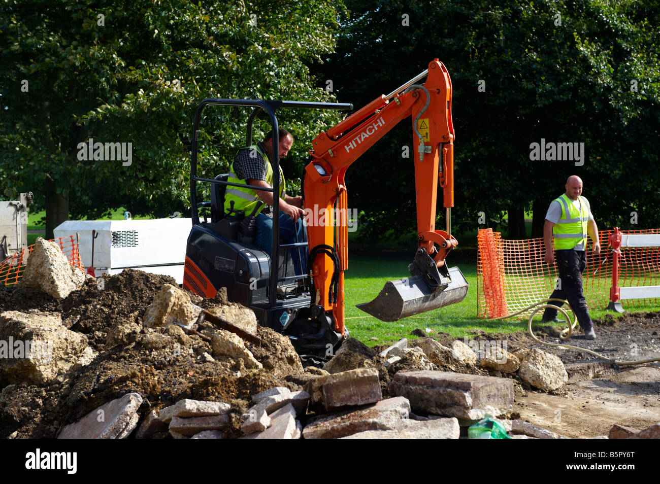 Workers digging with digger machinery Cambridge UK Stock Photo