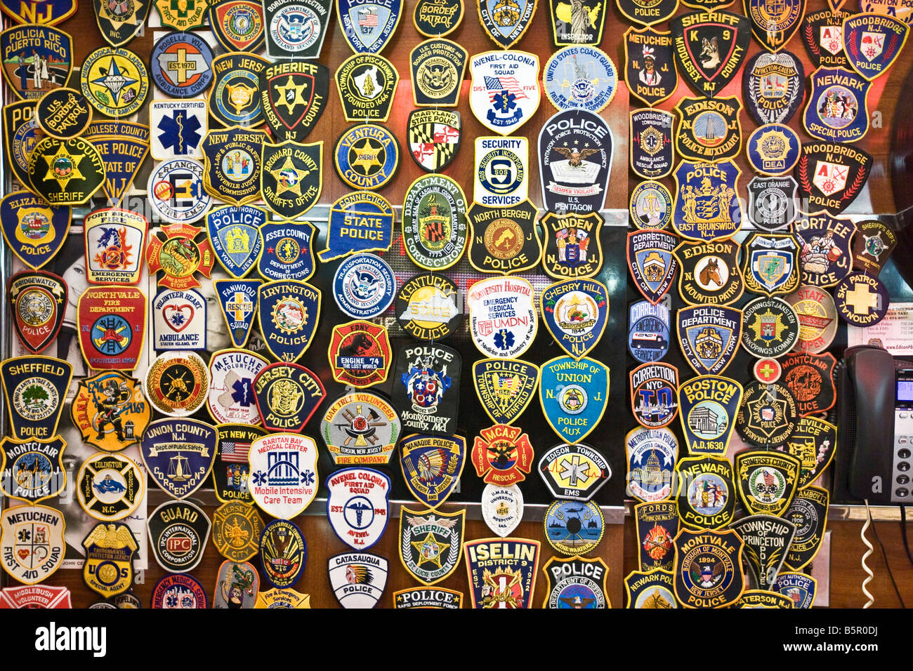 Police and emergency services badges on a wall Stock Photo